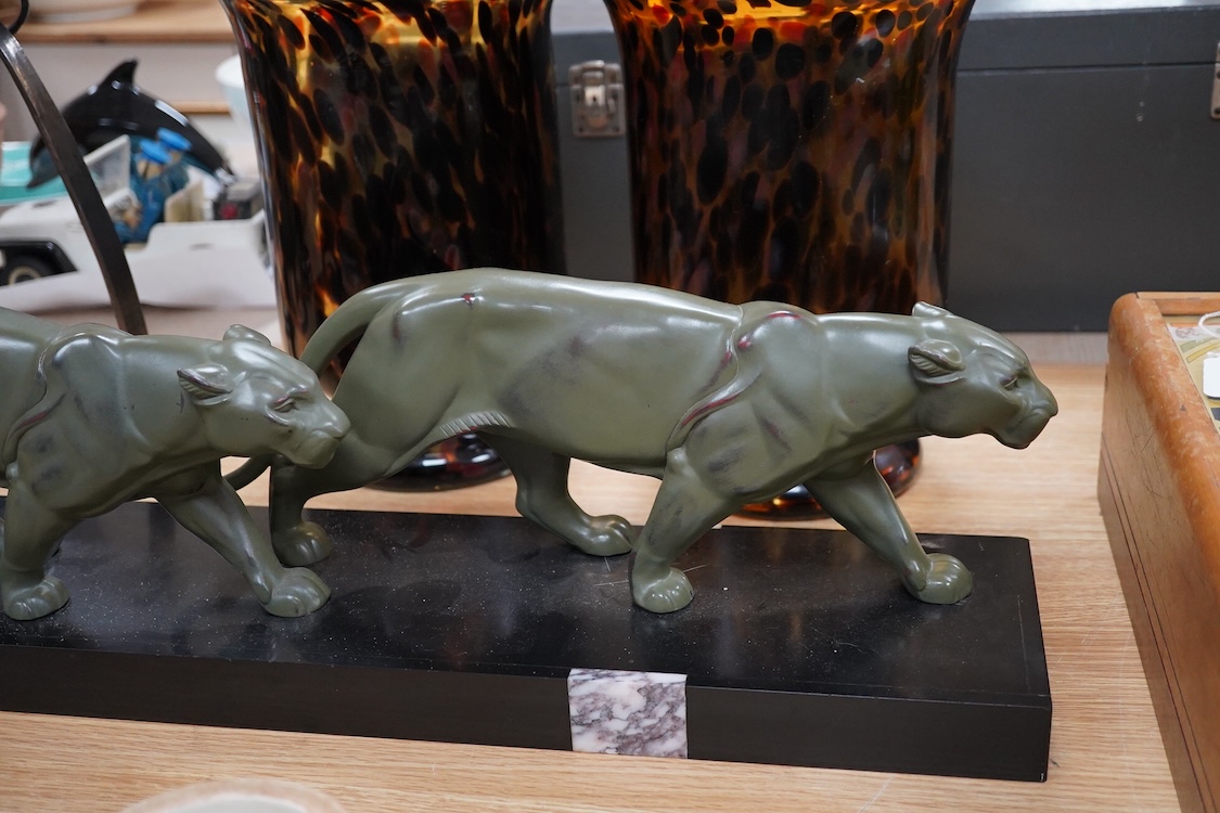 An Art Deco patinated spelter and marble figure of panthers, signed T. Cartier, 70cm